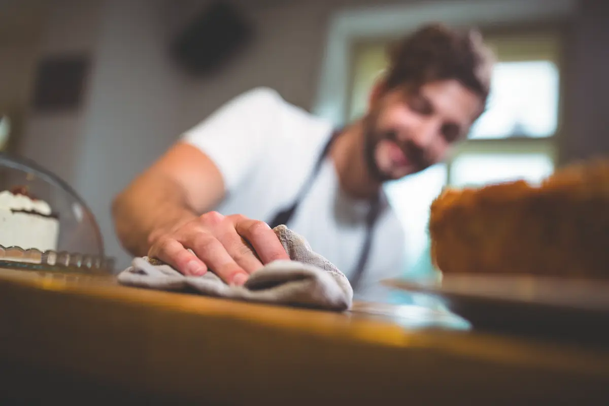 Cleaner wiping down a surface